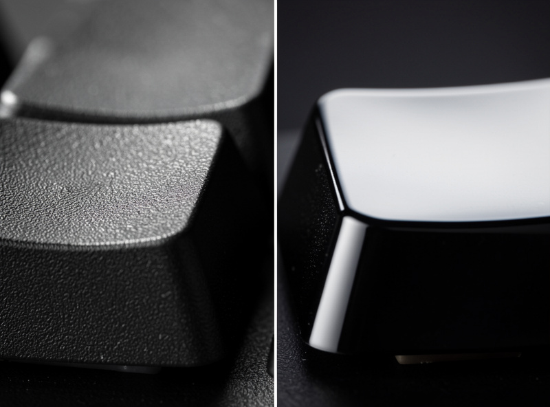 Close-up comparing a textured PBT keycap surface against a smoother glossy ABS keycap