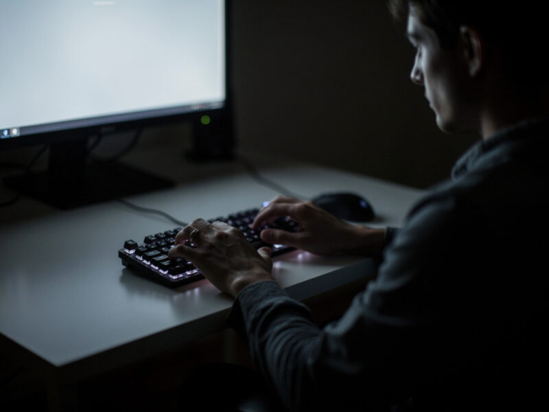 Person typing quietly on a mechanical keyboard in a dim room at night