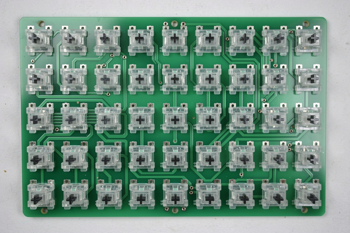 Mechanical keyboard PCB with switch LED slots pointing toward the top of the board