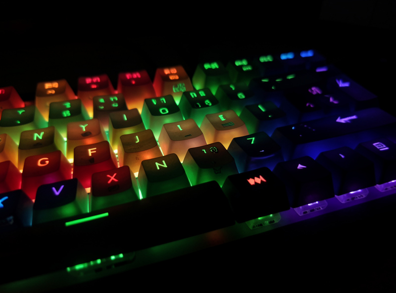 RGB mechanical keyboard at night with light shining up through shine-through keycap legends